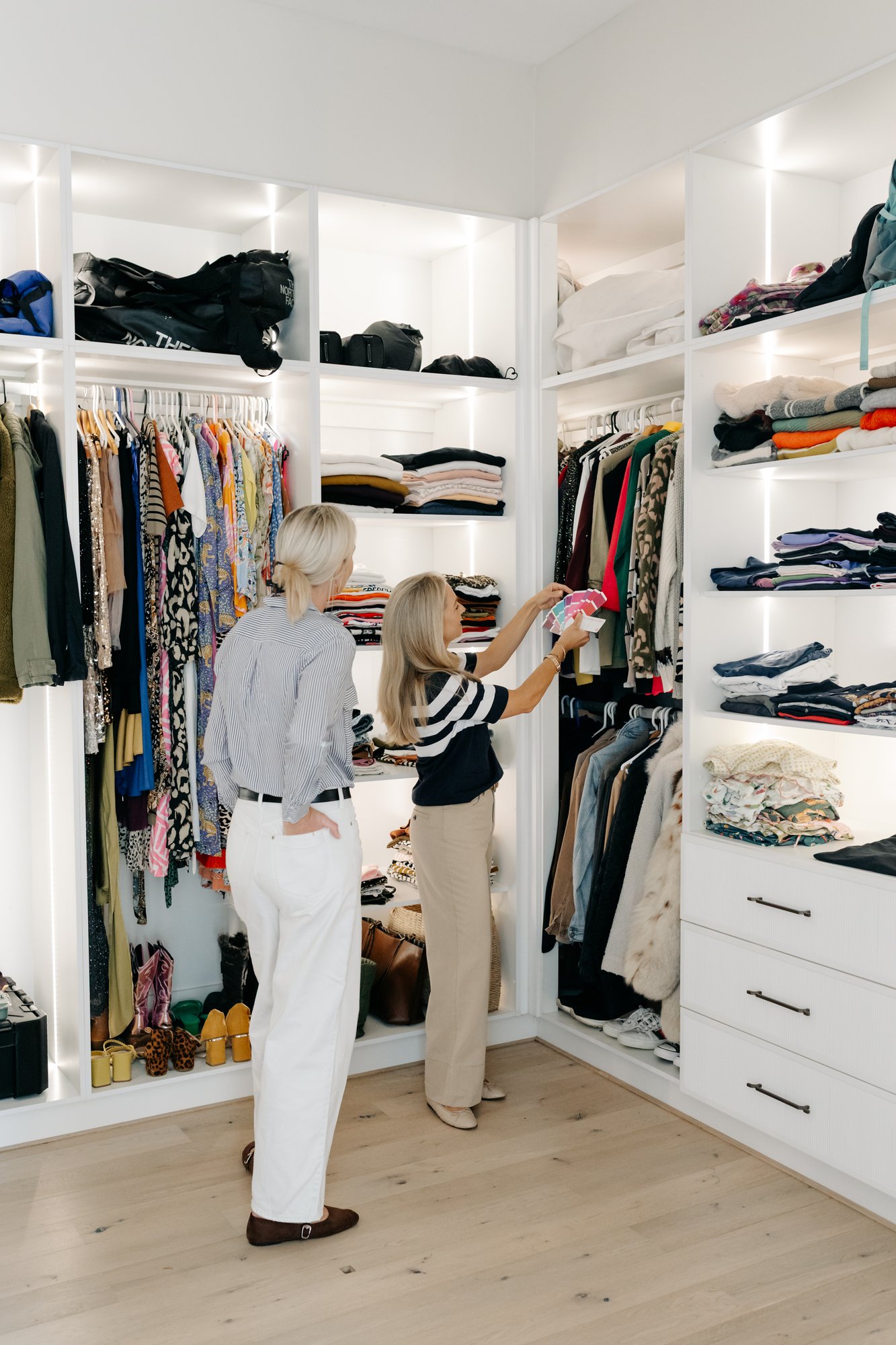 Sarah Reuter holding colour swatches against garments in a client's wardrobe